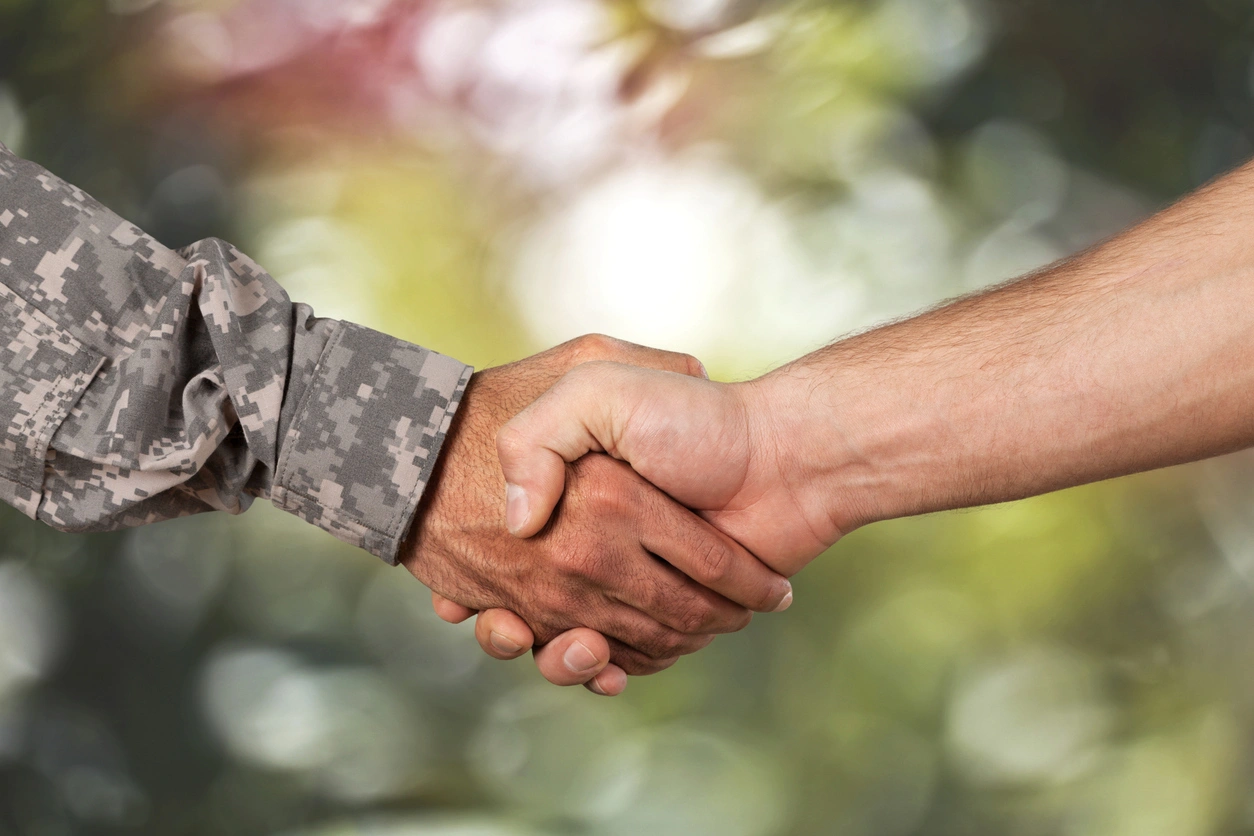 Building careers through partnership Veteran handshake representing career opportunities and mentorship