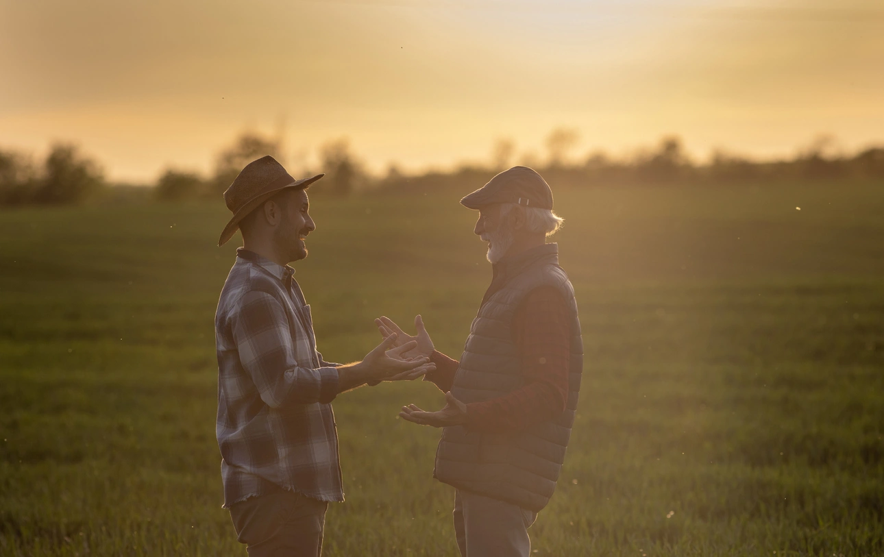 Building futures through mentorship Volunteer mentor speaking with veteran on a ranch